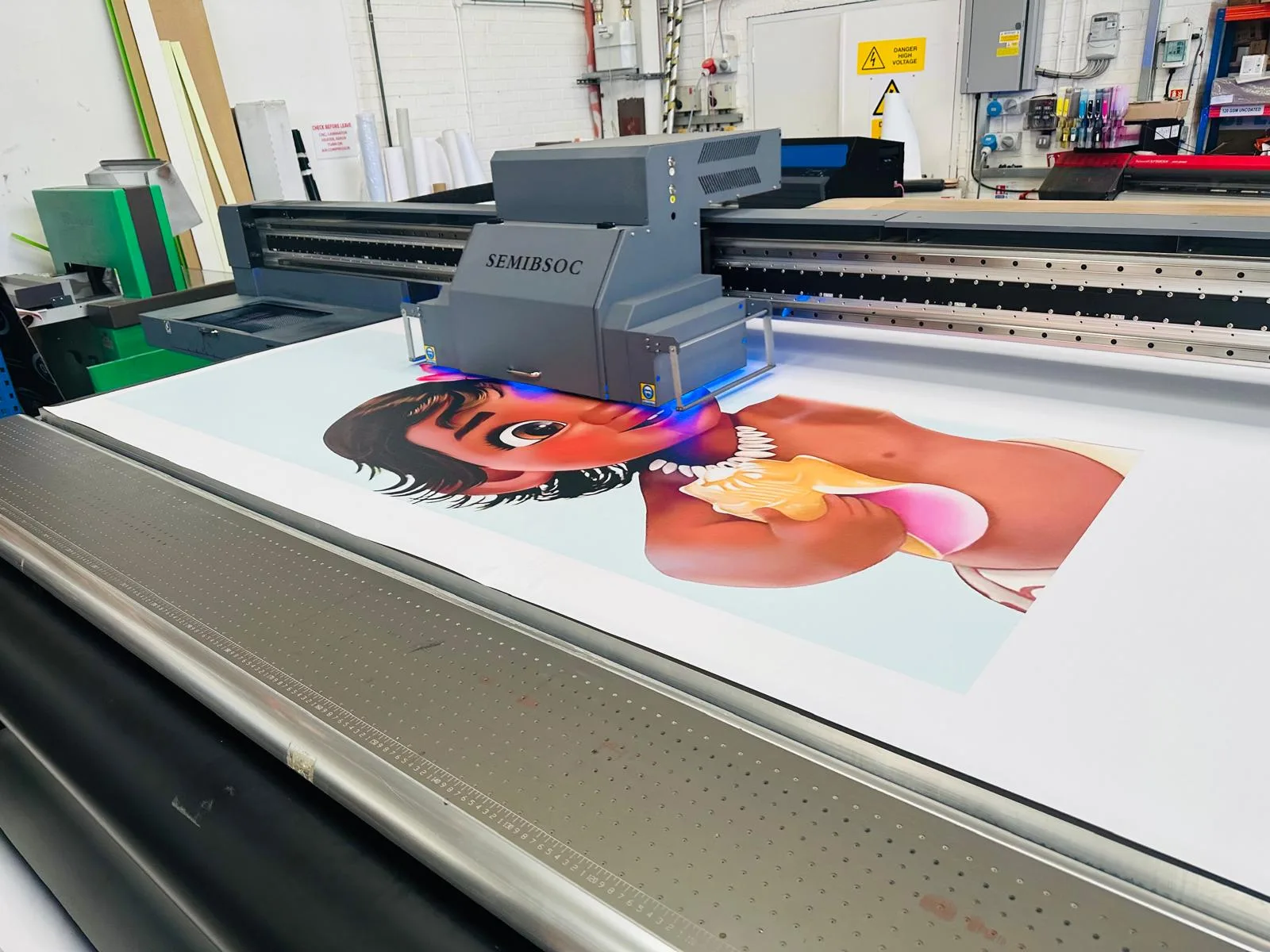 Large format printer printing high-resolution artwork onto a custom rigid display board.