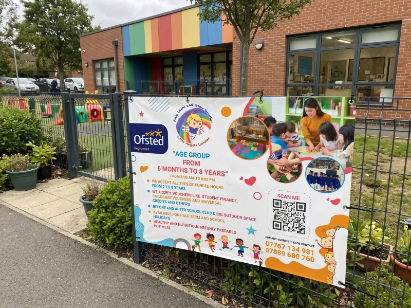 Personalised banner printing: a full-colour printed banner with eyelets and ties fixed to a metal fence outside a nursery